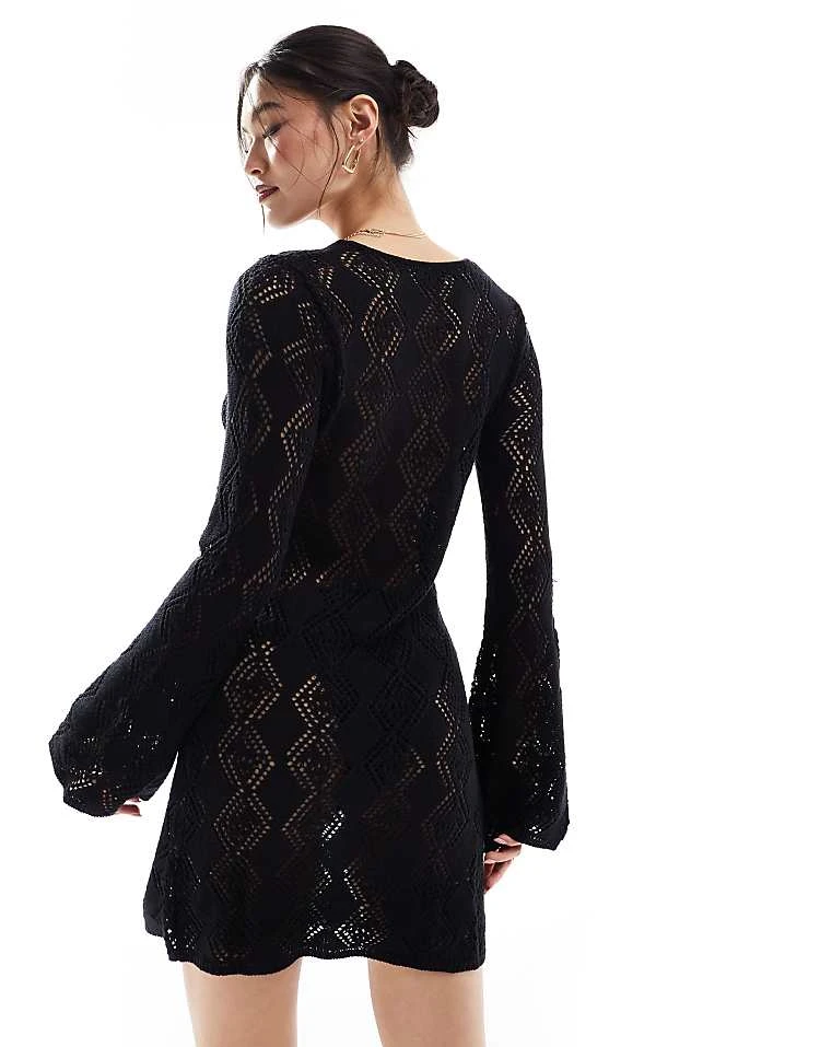 In The Style Exclusive Crochet Bell Sleeve Mini Beach Dress In Black For Women 2 In The Style Exclusive Crochet Bell Sleeve Mini Beach Dress In Black For Women - Image 2